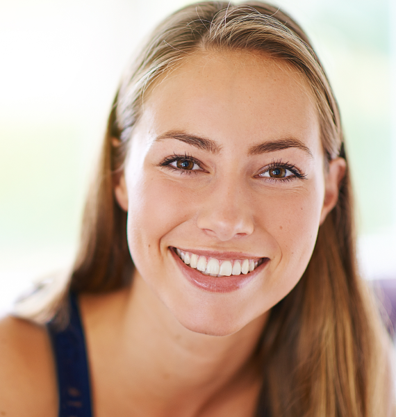 Two women smiling and laughing together outdoors